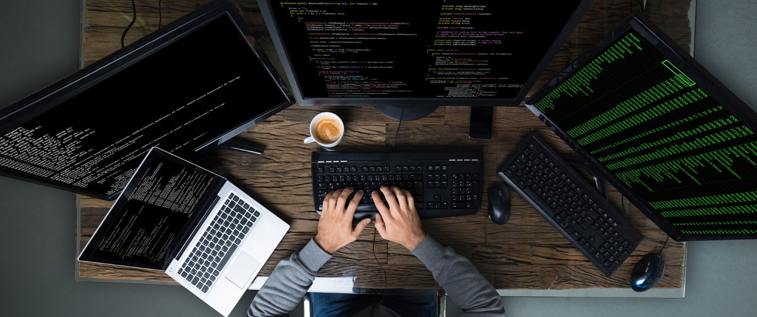 a person sitting in front of a laptop