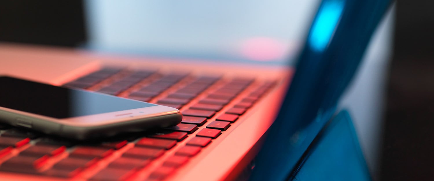 a mobile phone sitting on a laptop keyboard