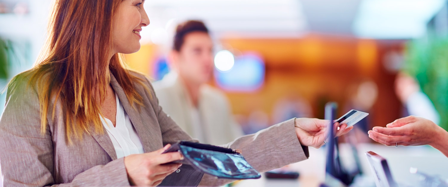 a woman sitting at a table using a laptop