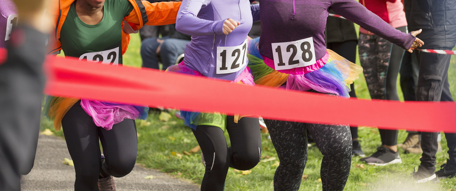 three women in a race approaching the finish line