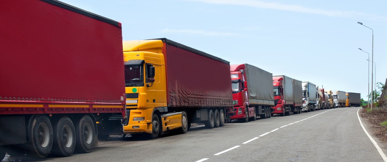 a large red truck driving down a street