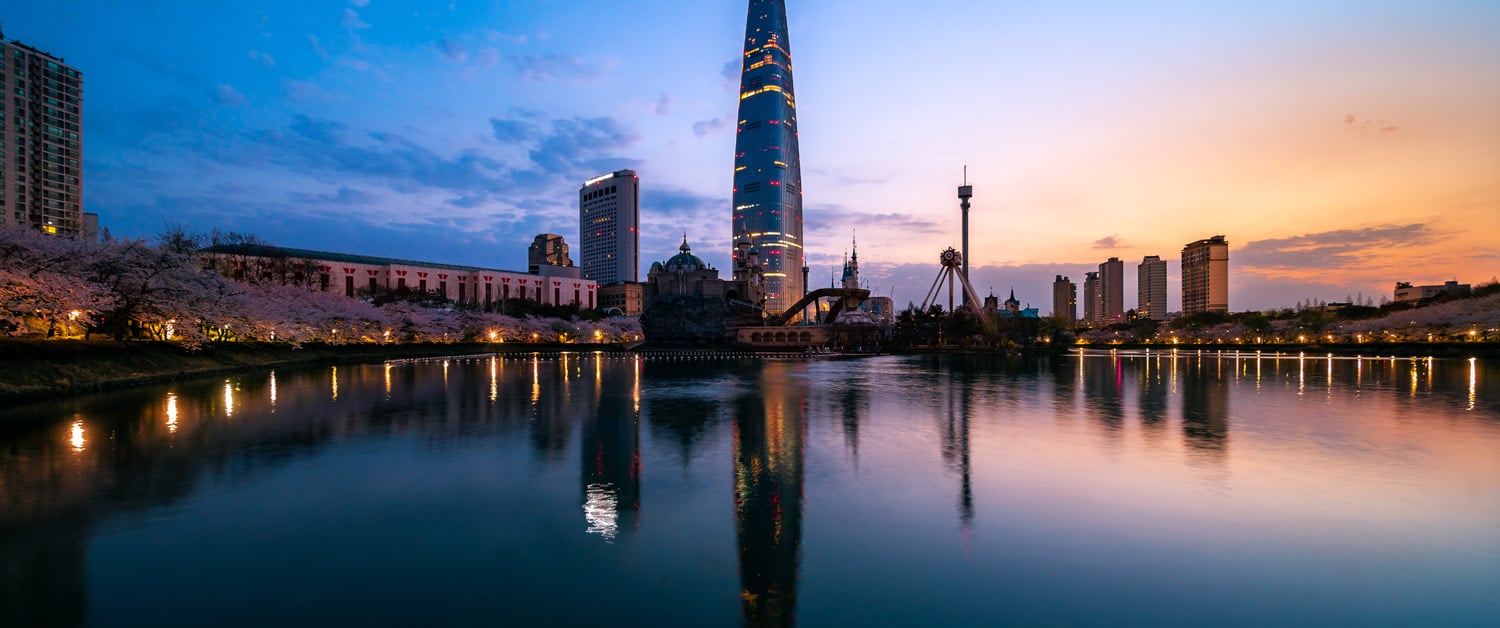 a bridge over a body of water with a city in the background