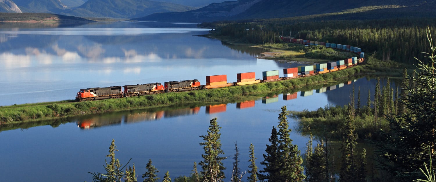 a train crossing a bridge over a body of water