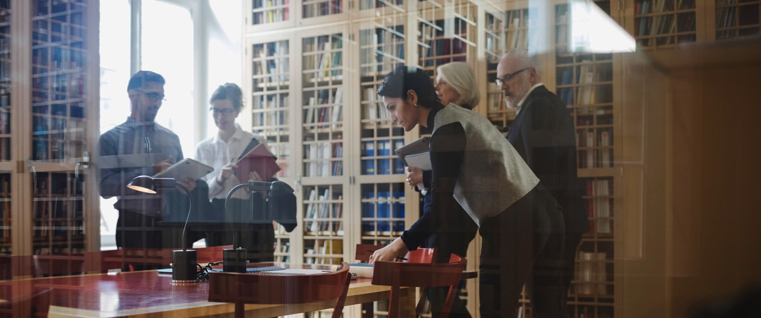 a group of people standing around a table