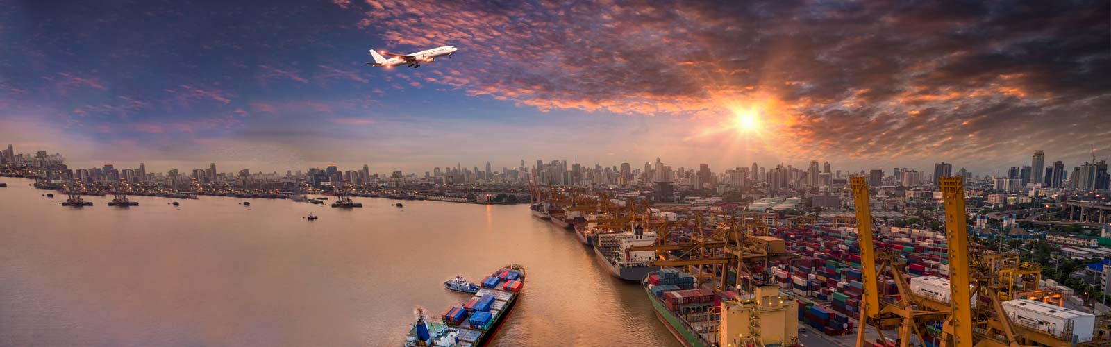 Airplane flying over shipping port 