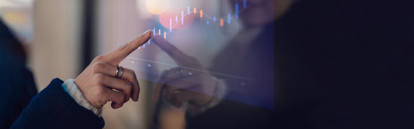 A hand pointing at data graphs 