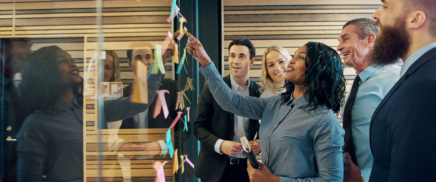 a group of people standing next to a window